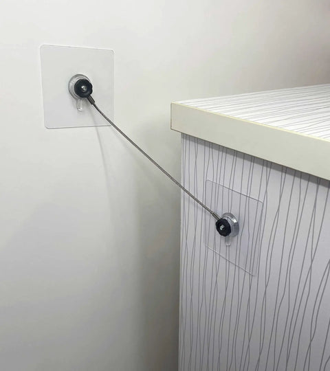 Heavy Duty Stainless Steel No Drill Furniture Straps to Securely Anchor Bookshelves and TVs Against Tipping for Toddler Safety without Damaging Walls Featuring Rock Solid Adhesive Backing Plus Quick Setup installed on a wall and furniture.