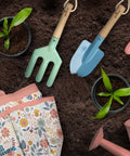 Kids Garden Tool Set For Young Gardeners Kid Friendly STEM Learning Kit With Tote Bag Lightweight Spade Watering Can Rake Fork Trowel And Gloves, tools displayed on soil.