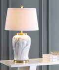 28-Inch White And Gold Ceramic Marble LED Table Lamp With Hand-Painted Faux Marble Base And White Linen Drum Shade For Living Room And Bedroom LED Bulb Included, displayed on a shelf.