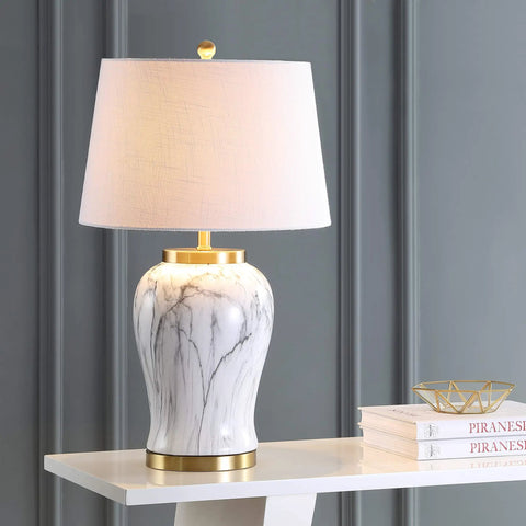 28-Inch White And Gold Ceramic Marble LED Table Lamp With Hand-Painted Faux Marble Base And White Linen Drum Shade For Living Room And Bedroom LED Bulb Included, displayed on a shelf.