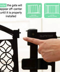 Close-up of black metal hinge on Extra Tall Walk Through Baby Gate For Doorways And Stairs Fits Openings From 28.5 To 48 Inches 36 Inch Tall Black Metal Safety Gate No Drill Pressure Mount Ideal For Babies And Pets At Home during installation with a hand adjusting the gate.