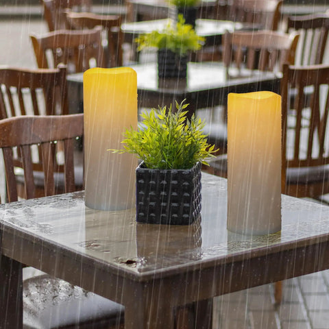 Waterproof Outdoor Flameless Pillar Candles 10x5 Inch Battery Operated LED With Remote And Timer on wet patio table