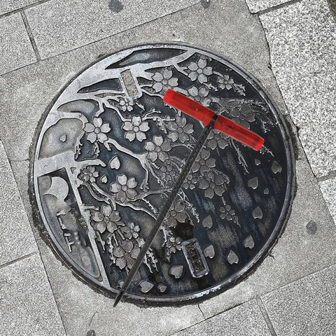 Rock Solid T Shaped Manhole Cover Lifter Hook Forged From Reinforced Steel Rod with no slip grip on decorative manhole cover.