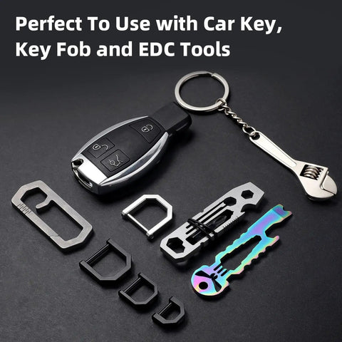 Rock Solid Titanium D Ring Keyholder With Hella Secure Crossbar Mount For Thick Car Ignition Fobs Pocket Knives And Daily EDC Essentials featuring assorted multi-tools and a car key.