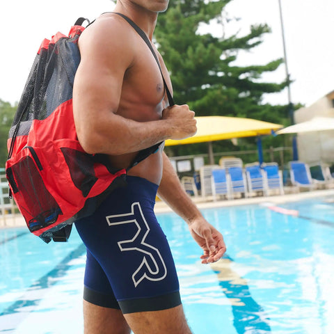Man by pool with Big Mesh Mummy Backpack For Wet Swim Gear, Gym, And Beach Workout Essentials, 25.25 x 19 in, red mesh.