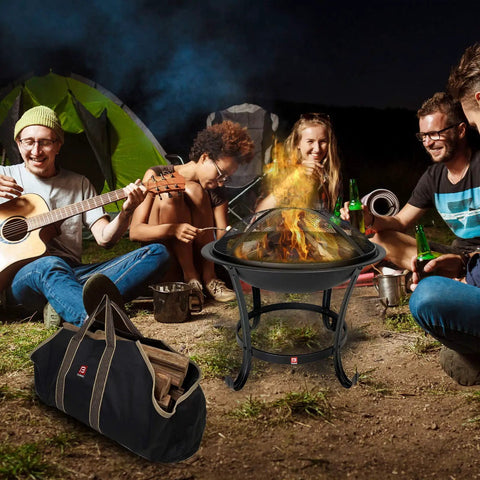 Extra Large Fire Pit BBQ Grill Bowl With Mesh Spark Screen Cover, Poker And Tote Bag in use at a bonfire setting with friends