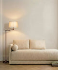 Caden LED Floor Lamp With Swing Arm Tall Bronze Standing Light beside beige sofa, perfect for living room reading and ambiance