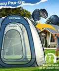 Man setting up 10x10 Pop Up Screen House Tent With Mesh Walls in backyard, showcasing easy installation.