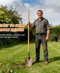 Man holding Beefy 55-Inch Black Locust Shovel Handle Replacement in garden, standing on grass with shovel.
