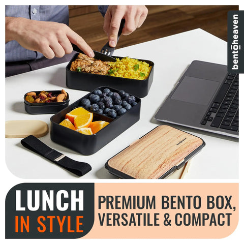 Premium Bento Box With 2 Stackable Compartments, 40 Oz Capacity, Includes Utensils, arranged on table next to laptop