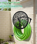 Heavy Duty Outdoor Garden Hose Reel and Wall Mount Holder With Tree of Life Metal Design mounted on brick wall with green hose