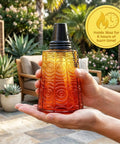Close-up of a red citronella glass table top torch held in hands, showing design details, outdoor setting in background. Citronella Glass Table Top Torches For Outdoor Patio 16oz Set Of 3 Red White Blue Decorative Torch Candles For Deck Backyard Parties Mosquito Repellent Lighting.