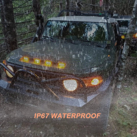 Truck in rain with Smoked Amber 4 Inch LED Front Grille Marker Light Kit, Four Pieces, Nine LEDs Per Light, full grille running.
