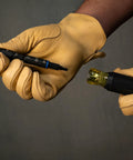 Close-up of hands with thick gloves assembling Impact Rated 11-in-1 Multi Bit Screwdriver And Nut Driver with interchangeable bits.