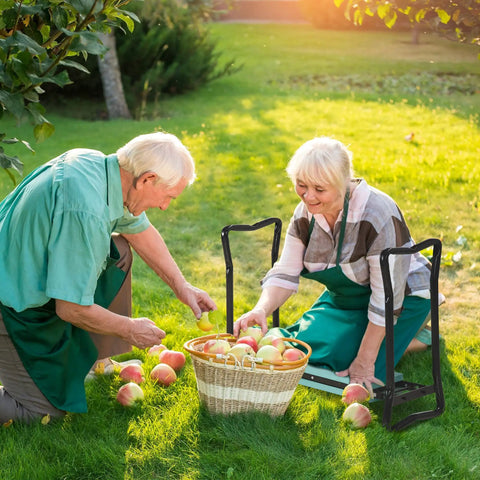 Two people using Padded Garden Kneeler And Seat Bench With Extra Thick Foam in a garden while picking apples from a basket.