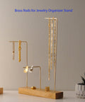 Jewelry organizer stand using brass rods for necklaces and earrings display on wooden base