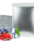 Fifty Pack 6x8 Inch Thermal Insulated Bubble Mailers for cold shipping, metallic silver foil, self-seal, stacked next to berries and ice cubes.