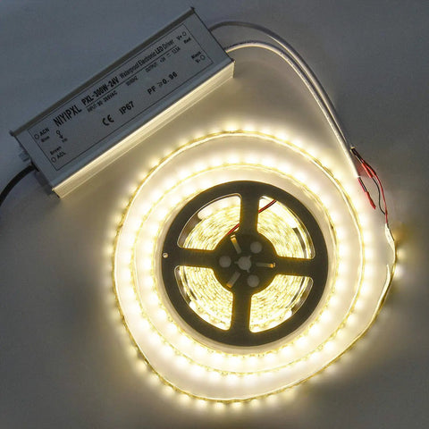 Go-To 300W LED Driver 24V DC Power Supply with 3-prong plug and waterproof enclosure next to coiled LED strip light