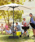Sturdy 40 Pound Outdoor Umbrella Base With Stainless Steel Tube And Heavy Duty Square Steel Stand In Black Powder Coat For Patio Deck Or Garden No Maintenance Required Rust Proof Finish at a family picnic in a garden area.