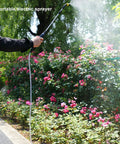 Person using Go-To Electric Garden Sprayer For Easy Watering And Dosing, 9.8Ft Hose, Adjustable Spray in garden with flowering bushes