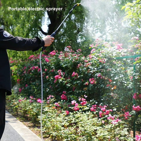 Person using Go-To Electric Garden Sprayer For Easy Watering And Dosing, 9.8Ft Hose, Adjustable Spray in garden with flowering bushes