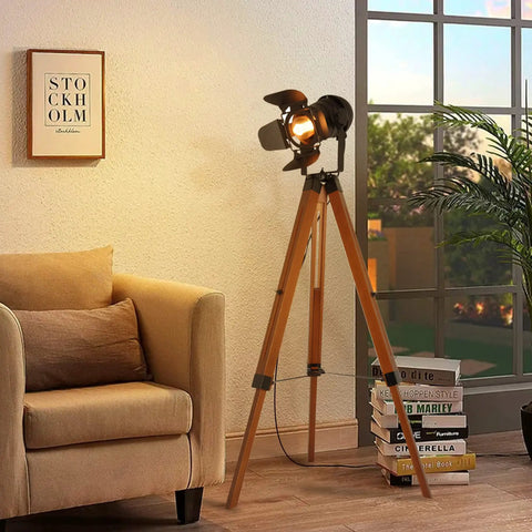 Retro Industrial Tripod Floor Lamp With Black Metal Frame And Natural Wood Legs, Stage Light Style Head, in living room setup