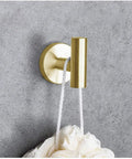 Dope Brushed Gold Bathroom Hardware Set Includes 16 Inch Hand Towel Bar And Toilet Paper Holder And Two Robe Hooks In Durable SUS304 Stainless Steel For A Slick Modern Bath Update showing robe hook on grey wall
