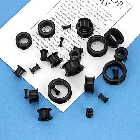26 Piece Silicone Ear Tunnels Set 8G To 1 Inch Hollow Flexible Soft Ear Stretching Kit on paper background