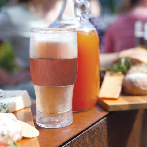 Level Up Your Chill Game With These Freezable Pint Glasses Double Walled Insulated Tumblers That Keep Beer And Iced Coffee Straight Frosty Built To Last Set Of Two Wooden Handles, showing icy drink in double walled tumbler.