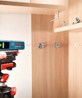 Person using Line And Point Laser Level With 65 Ft Range, Two Bubble Vials, Batteries Included, And Versatile Mount For Easy Setup