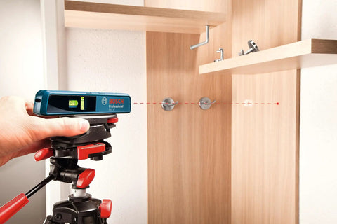 Person using Line And Point Laser Level With 65 Ft Range, Two Bubble Vials, Batteries Included, And Versatile Mount For Easy Setup