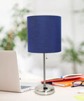 Brushed Steel Desk Lamp With Built In Charging Outlet And Drum Fabric Shade on an office desk with laptop and books
