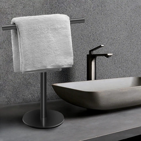 Hand Towel Holder Stand For Bathroom Vanity Countertop Matte Black Finish Free Standing Design Space Saving Movable T Shape Towel Bar Rack For Kitchen And Bath next to a modern sink.