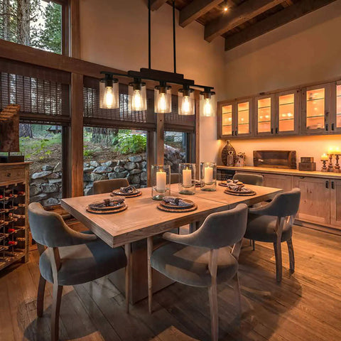 Five Light Farmhouse Dining Room Chandelier Over Table In Matte Black With Rustic Wood Accents And Clear Glass Shades above dining table