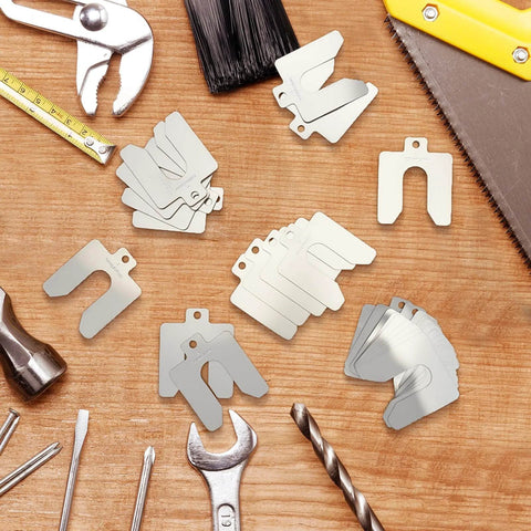 80 Piece Set Stainless Steel Slotted Shims Kit 2 by 2 Inch With Eight Thicknesses From 0.001 To 0.075 Inch, viewed on wooden surface