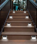 Outdoor Solar Deck Lights Pack Of 6, Waterproof Stainless Steel Stair And Path LED Lights illuminating wooden stairs