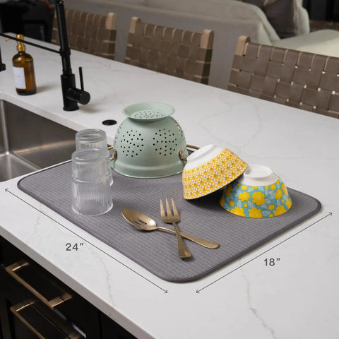 Top Shelf Microfiber Dish Drying Mat Extra Large 18 X 24 Inch Countertop Pad with dishes and utensils on kitchen counter.