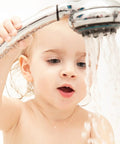 Child holding a showerhead, enjoying water flow, highlighting the ease of use of the Score Instant Hot Water With This Beast-Mode 26.9 KW Electric Tankless Water Heater Engineered For Full Whole-House Flow With Zero Fuss Super Easy Install For Any Gig 3Phase 240V Power Gets You Streaming Hot Water Fast Reliable Goods For Home Or Business.