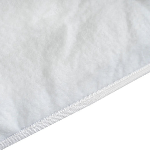 Close-up of ironing board cover with thick three-layer padding, 100% cotton, showing texture and elasticized skirt edge.