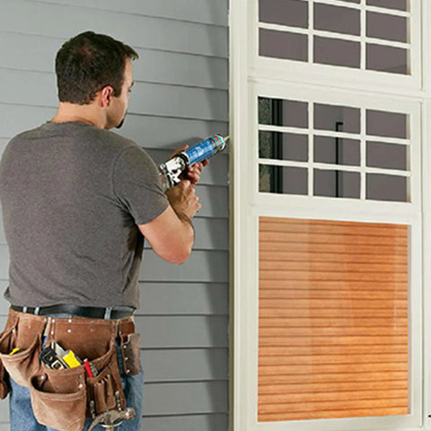 Person applying P625 Crack Flex Sealant White 12 Pack DIY Friendly Polyurethane Construction Sealant to window frame.