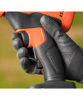 Close-up of hand gripping the trigger of the Premium 18V Cordless Hand Grass Trimmer With 2Ah Lithium Battery for ergonomic use.