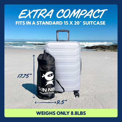 Beach Tent Sun Shelter UPF50 Plus Easy Pop Up Canopy bag next to suitcase on beach showcasing compact size and portability.