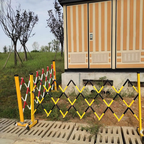 Tough As Nails Traffic Barricade Heavy Duty Industrial Crowd Control Barrier For Construction Zones And Large Gatherings Uv Resistant FRP Expandable Safety Fence Red White in expanded position beside building.