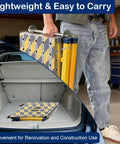 Heavy Duty Steel Welding Table Workbench With Slick Glide Casters Adjustable Height Folding Scaffold And Rock Solid Non Slip Platform Built Like A Tank For Garage Hustle being carried from a car trunk.
