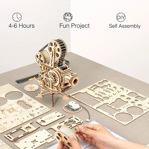 Vitascope 3D Wooden Puzzle Kit For Adults with parts laid out, showing mechanical model assembly setup on a table.