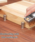 Hand using tool alongside Two Pack Stainless Steel Quick Bench Dog Pins For MFT Tables And Woodworking Workbenches on wooden board.