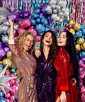 Three people in front of a 135 Piece Disco Balloon Arch Kit With Silver Blue Green Purple Hot Pink And Gold Metallic Balloons And Star Foil Balloons.