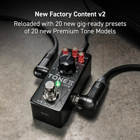 Tonex One AI MultiFX Micro Pedal with 20 presets, A/B button visible, cables connected, on gray surface