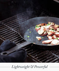 Budget-Friendly Carbon Steel Frying Pan 12 Inch on grill with octopus cooking, showing lightweight pre-seasoned versatility