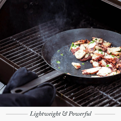 Budget-Friendly Carbon Steel Frying Pan 12 Inch on grill with octopus cooking, showing lightweight pre-seasoned versatility